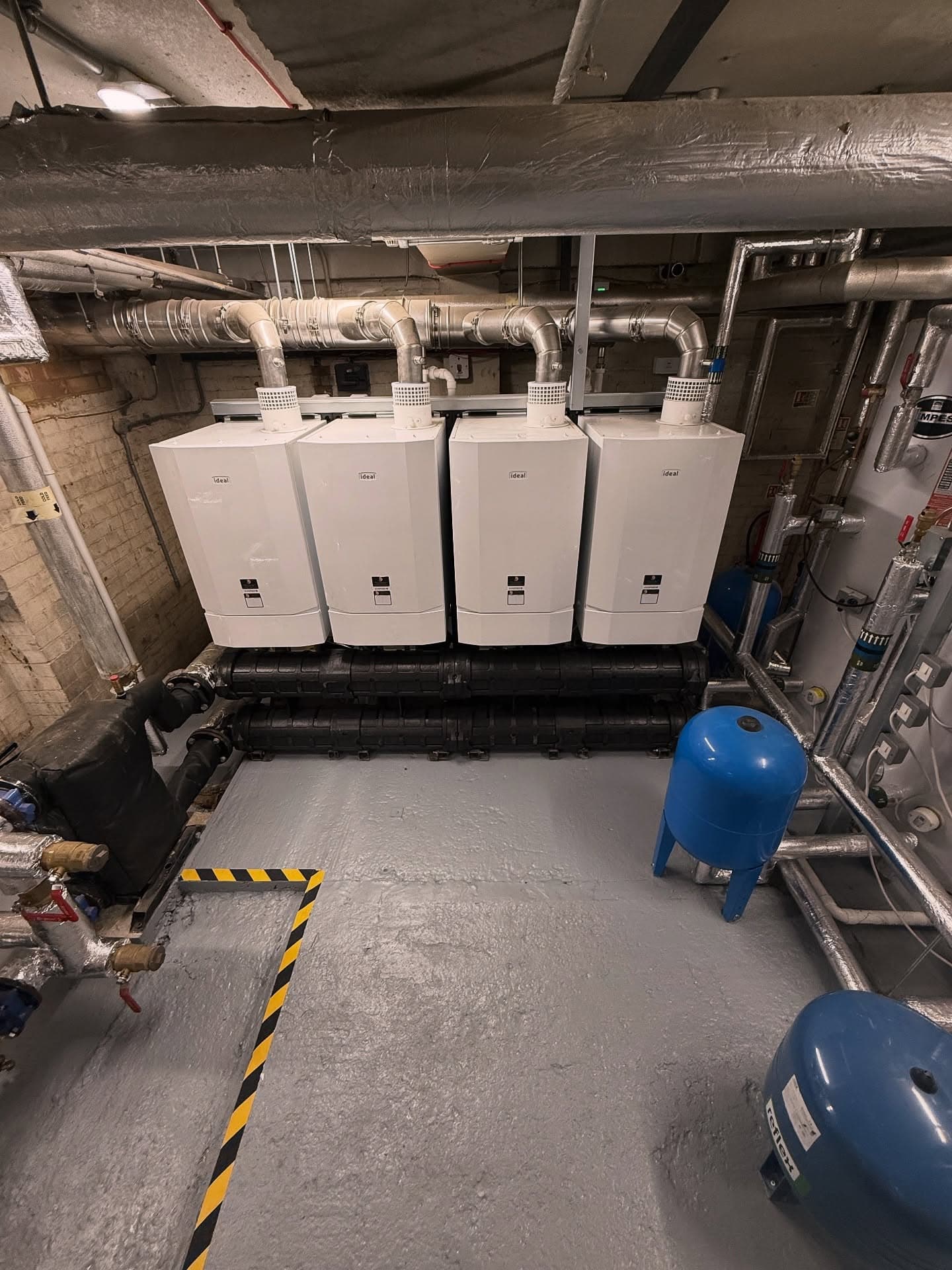Four-boiler cascade wall in a care home plant room installed by Spitfire Commercial